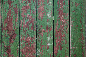 background of an old wooden fence with green cracked paint for writing texts