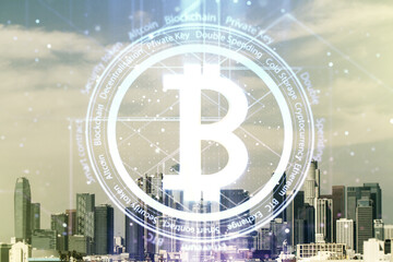 Virtual Bitcoin hologram on Los Angeles skyline background. Multiexposure