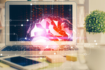 Double exposure of work space with computer and human brain drawing hologram. Brainstorm concept.