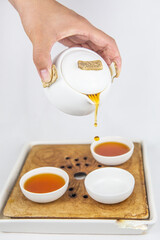 A set of Chinese traditional pottery teapot and cups, serving black tea.