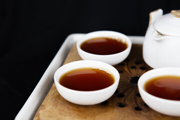 A set of Chinese traditional pottery teapot and cups, serving black tea.