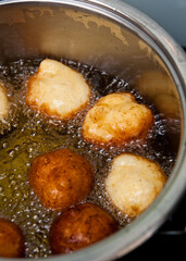 Homemade donuts making boiling in hot oil
