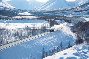 Scenic winter landscape of Kolyma Highway (Road of Bones) with amazing Verkhoyansk mountain Range on the background. Adventure travel in Russia from Yakutsk to Magadan