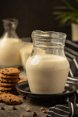milk products tasty healthy dairy products on a table on sour cream in a bowl, cottage cheese bowl, cream in a a bank and milk jar, glass bottle and in a glass.