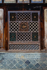 Traditional Chinese wooden sculpture on vintage windows. 