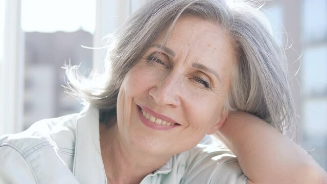Pretty senior lady smiling on camera, natural beauty, self-acceptance and aging