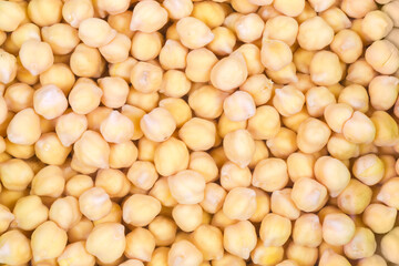 Background of the yellow chickpeas soaked in water before cooking