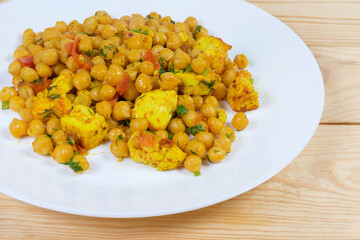 Chickpeas, stewed with Adyghe cheese on dish, fragment close-up