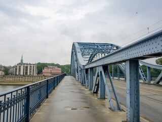 Fototapeta na wymiar Steel arch truss of the road bridge across the river