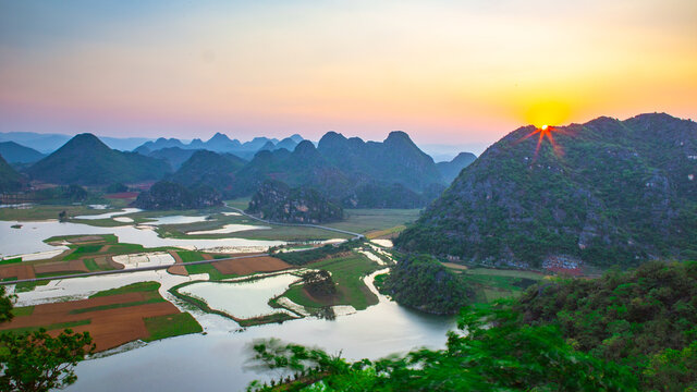 Sunset View of Puzhehei, a typical karst landscape in Yunnan, China. © Zimu