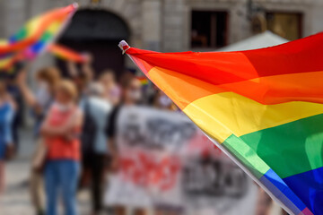 LGBT rainbow flag on foreground as a symbol of equality rights with blurred background. Equality...