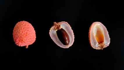 Fresh lychees on black background.