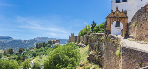 Panorama of the old city wall and surrounding mountains in Ronda, Spain