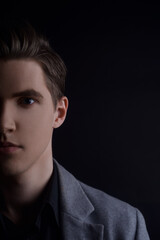 Portrait of a man on a black background. Handsome man, gender, creative photo