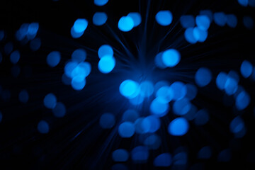 Blue abstract round particles and lines with bokeh and blur.
