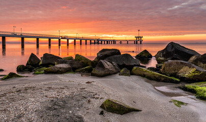 Dramatic sunrise with colorful clouds over the sea bridge in Burgas. Symbol of the sity.	
