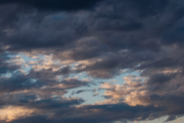 Naklejka na ściany i meble stormy sky at sunset as a background