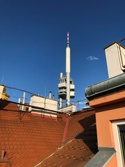 futuristic Television Tower behind red ceramic tiled rooftops