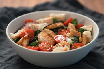 Caesar salad alternative with kale and turkey in white bowl