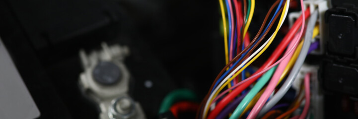 Close-up view of large wide cable with multicolored wires and connectors. Electric connector plug of car engine. Service center for automobile repair concept