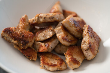 fried chicken fillet slices in white bowl