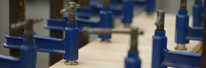 Metallic utilities used on carpentry workbenches for wood crafting works in big rusty workshop openfield factory. Manual manufacturing process concept