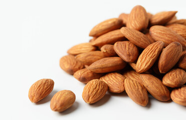 .almonds situated arbitrarily on the white background with clipping path