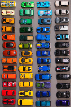 Rows of toy cars on the background.