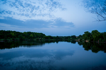 beautiful evening landscape. sunset on river. calm water in pond.