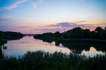 Fototapeta na wymiar beautiful evening landscape. sunset on river. calm water in pond.