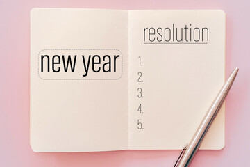 New year resolution on notebook with pen.