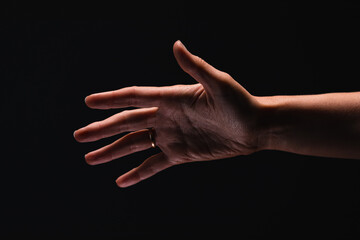 Fototapeta premium Palm of women’s hand on the black background.