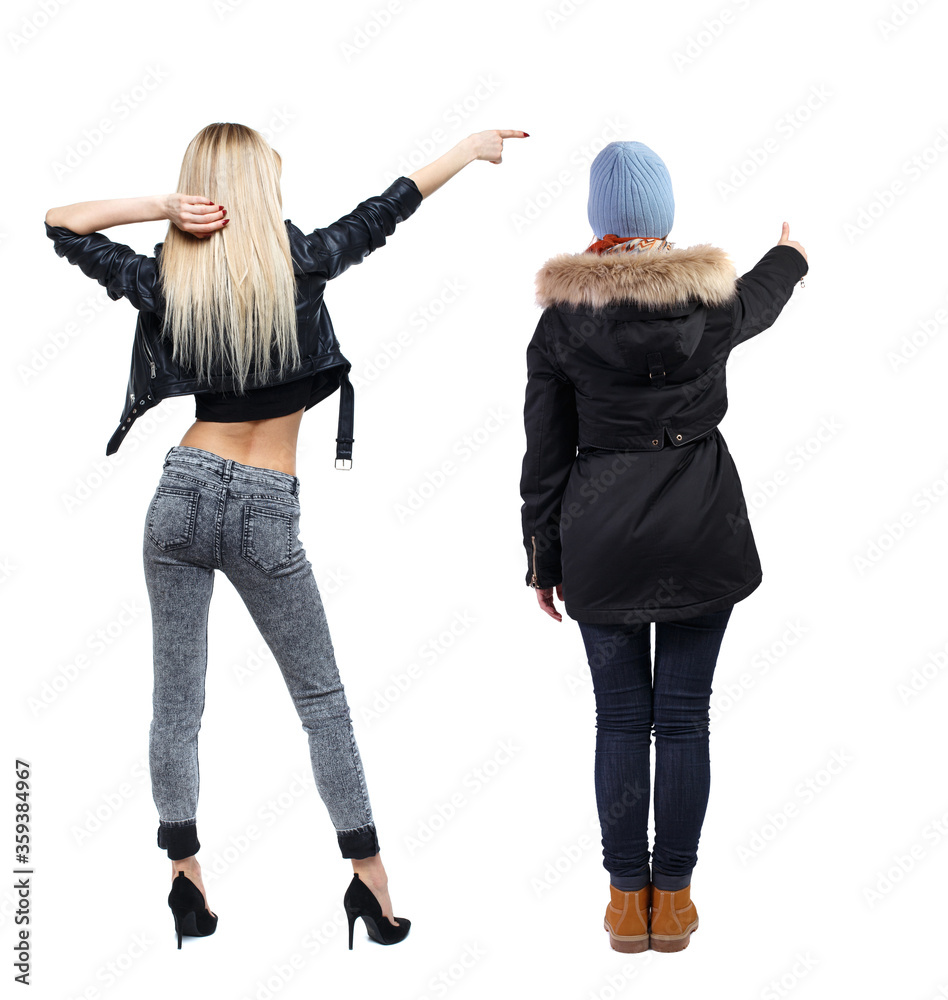 Poster Back view of two pointing young girl in winter jacket.