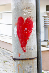 A Heart Shaped Spray Painting On The Utility Pole