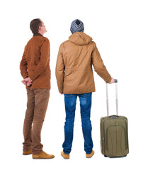 Back view of two man in winter jacket traveling with suitcas.