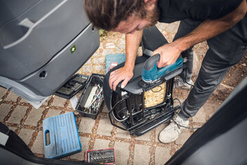 Man customizing a van seat with a jigsaw