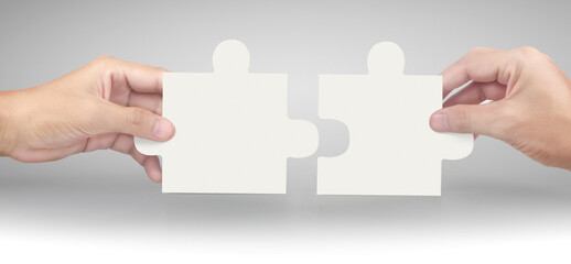 Hand of connecting jigsaw puzzle