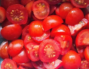 evocative closeup image of small tomato salad cut and ready to be seasoned
