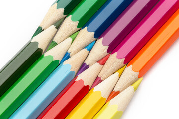 A lot of colorful wooden pencils on a white background