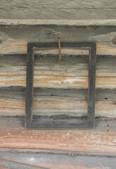 Old wooden dark frames hanging on rural wooden wall with copy space