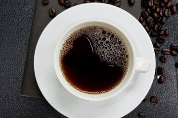 Close-up of black coffee in a white mug on a black background