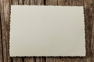 Old vintage photo template (mockup) on wooden background. Empty retro card, textured paper.