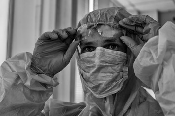 Tired doctor in protective suit at the hospital