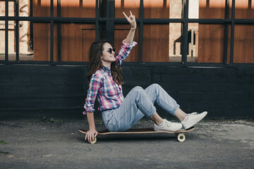 fashion woman sitting on skateboard