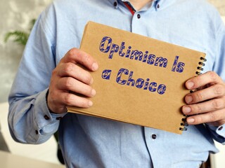 Motivation concept meaning Optimism Is a Choice with sign on the page.