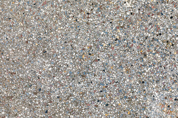 old concrete floor with small pieces of marble and natural stones