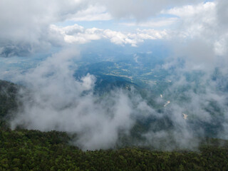 Fototapeta na wymiar 新緑の恵那山山頂上空よりガス立ち昇る中津川方面を空撮