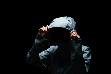 Fototapeta na wymiar Portrait of Invisible man in the hood on black background.