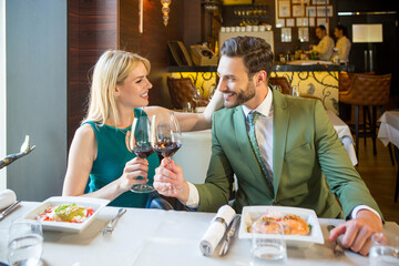 Attractive young couple having lunch in the restaurant