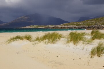 Luskentyre Beach on the Isle of Harris in the Western Isles of Scotland with an approaching storm and threatening clouds.